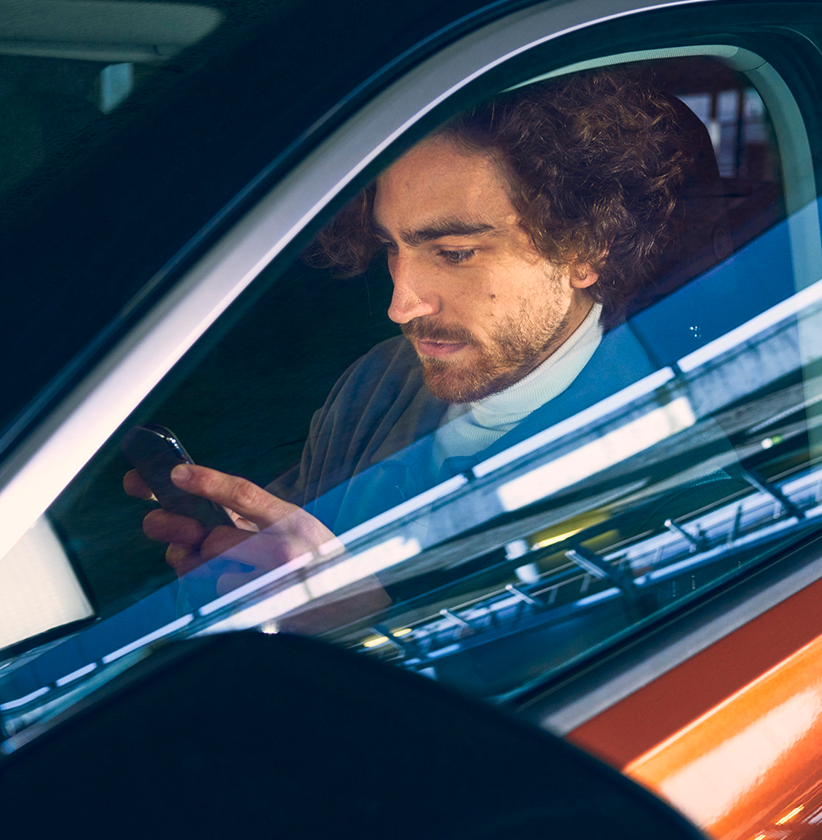 Man sitting in his car on the phone