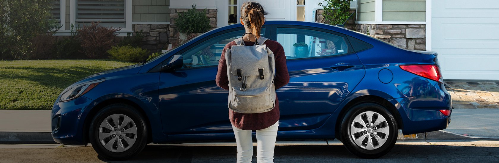 A Student standing next to a Hyundai car