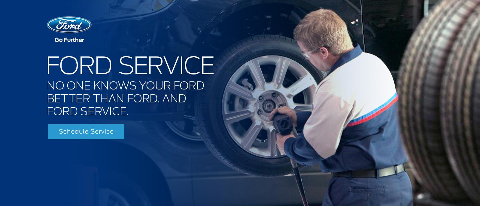 Ford Service tech installing a tire on a vehicle