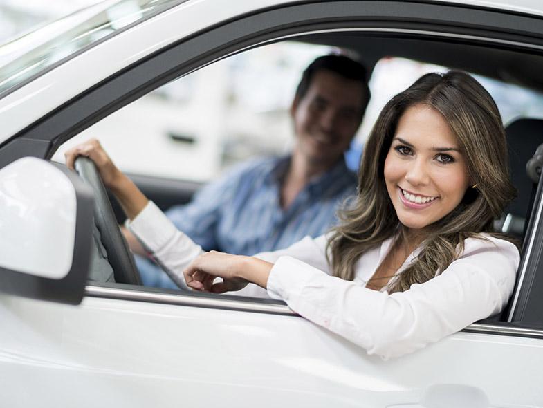 Woman smiling in car certified pre-owned car