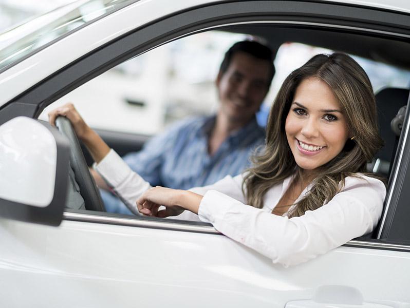 Woman smiling in car with man