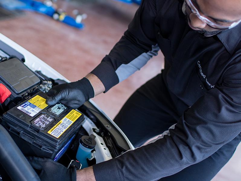 Chevy service technician changing vehicle battery
