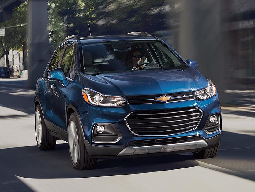 2018 Chevy Trax driving down a city street.