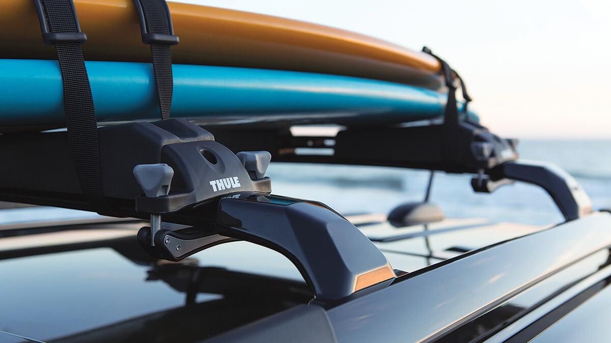 Close-up of a Thule Watersports Carrier roof rack on a vehicle.