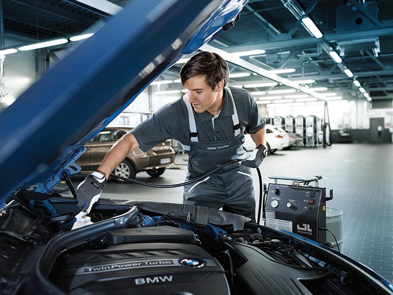 Certified BMW Technician performs routine vehicle maintenance.