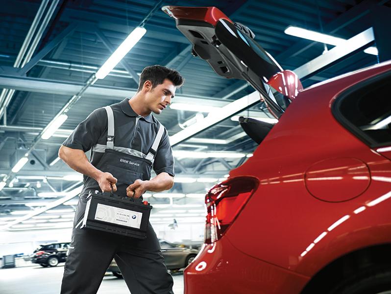 A BMW Certified Service Technician replacing a battery.