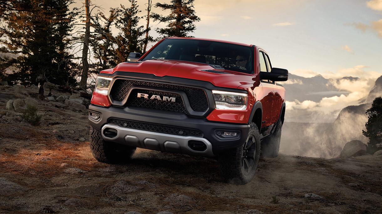 Ram 1500 driving on a dirt road.