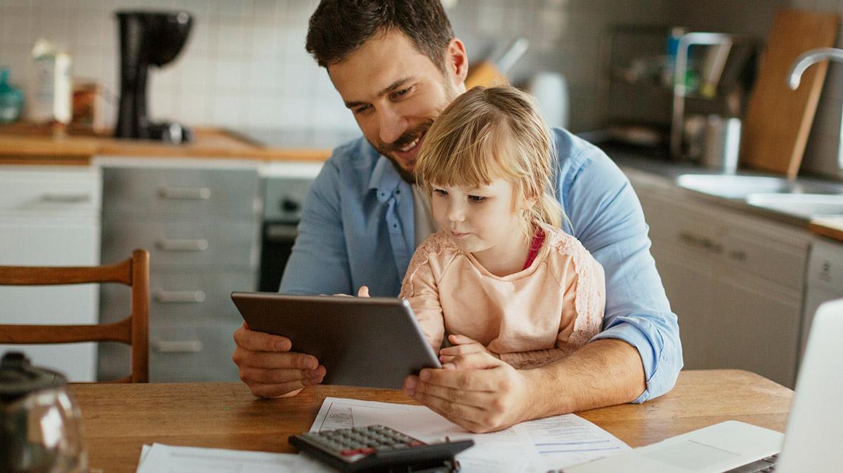 A man with his daughter reviewing finances.