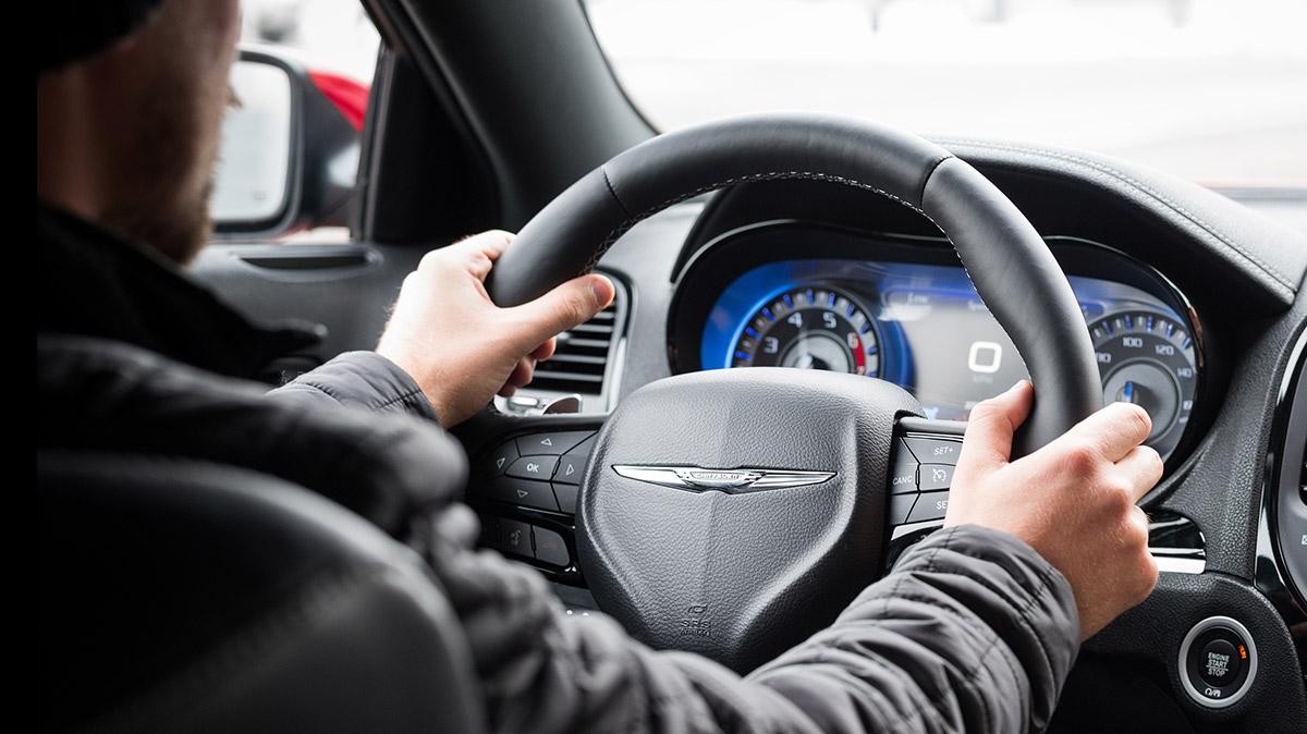 Interior view of a man behind the wheel of a Chrysler 300.