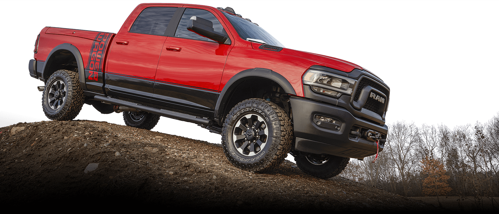 A RAM 1500 truck on top of a dirt hill.