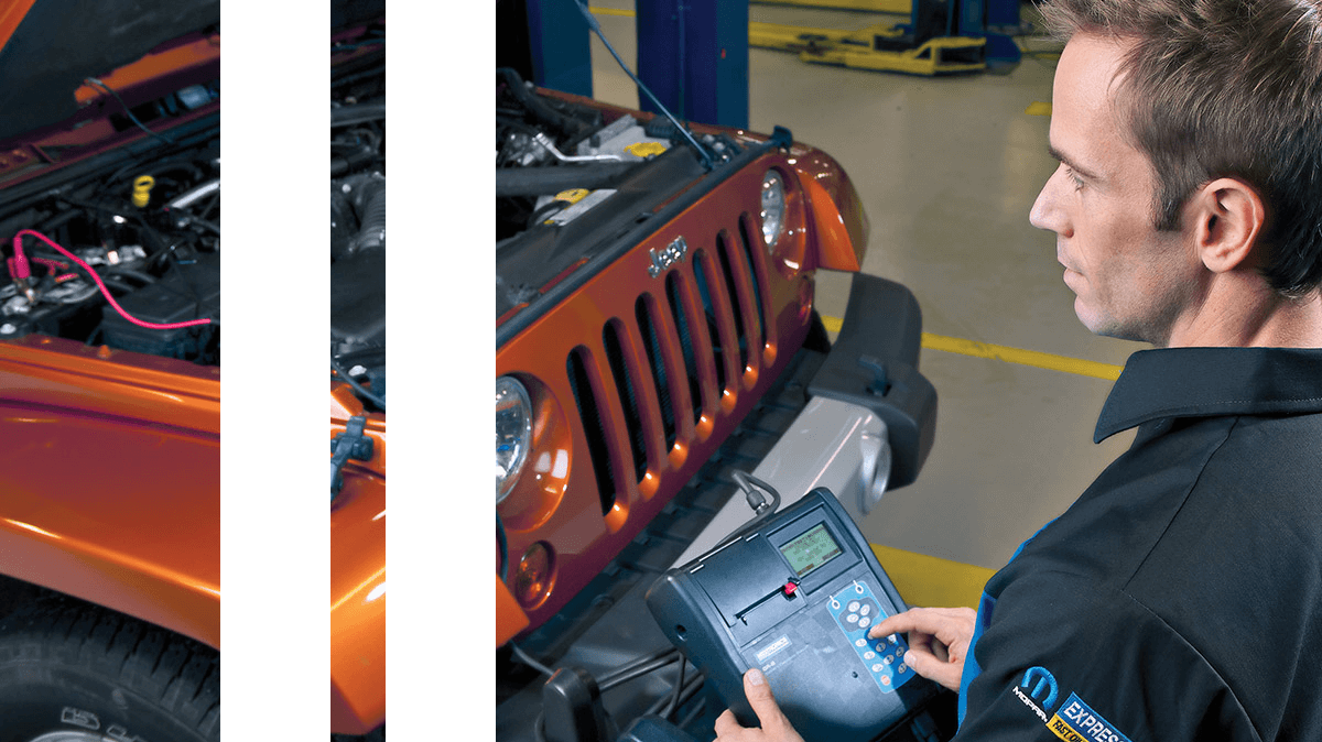 A technician running diagnostics on a Jeep Wrangler.