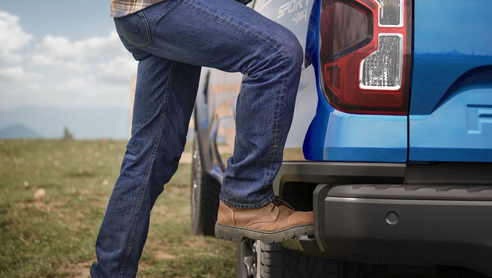 A 2024 Ford Ranger® in Velocity Blue with the Boxside Step being demonstrated by a person. XLT shown.  