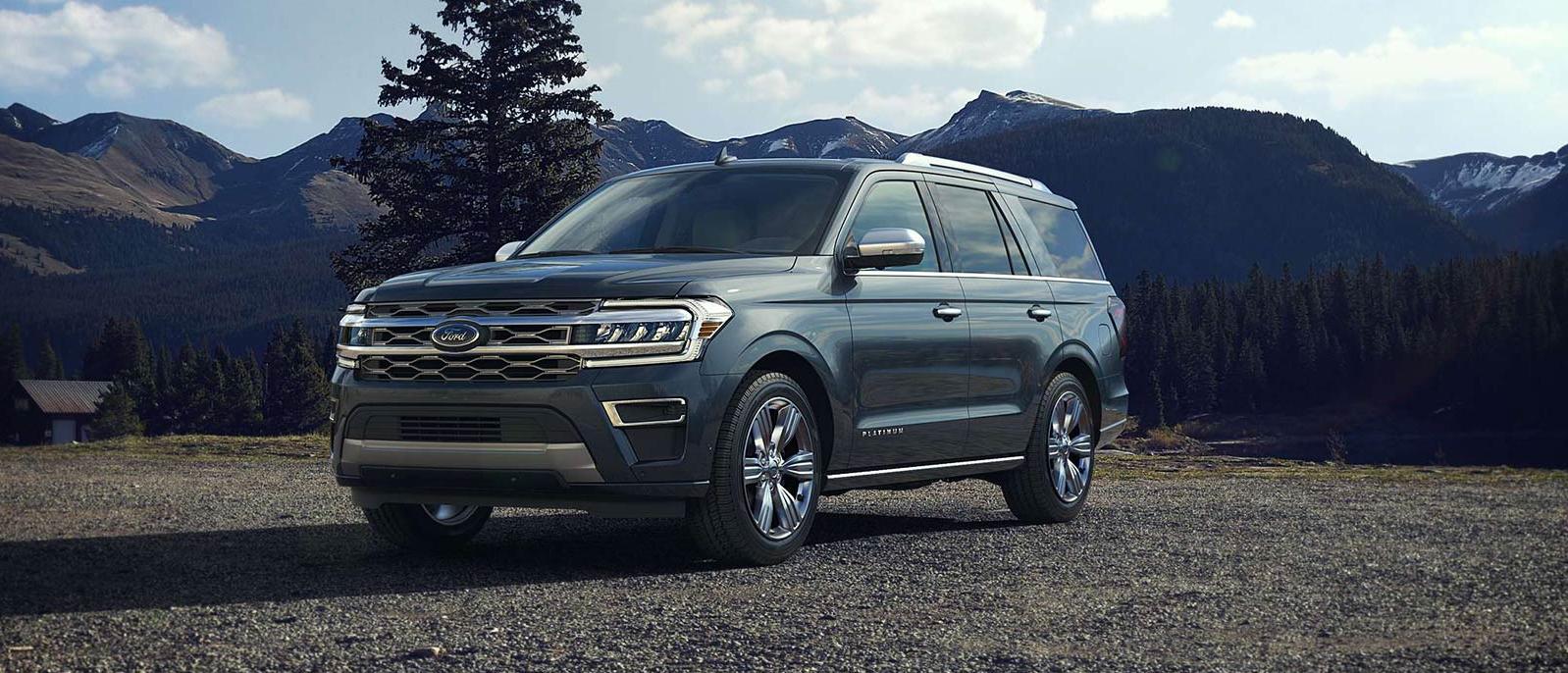 2022 Ford Expedition is parked on the land with mountains scenarios in the background.