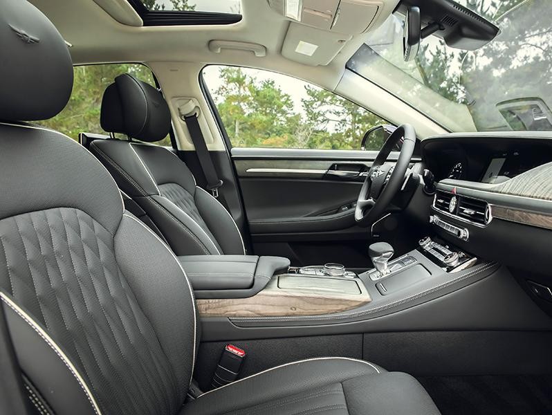 Interior view of the front seats of a Genesis G90.