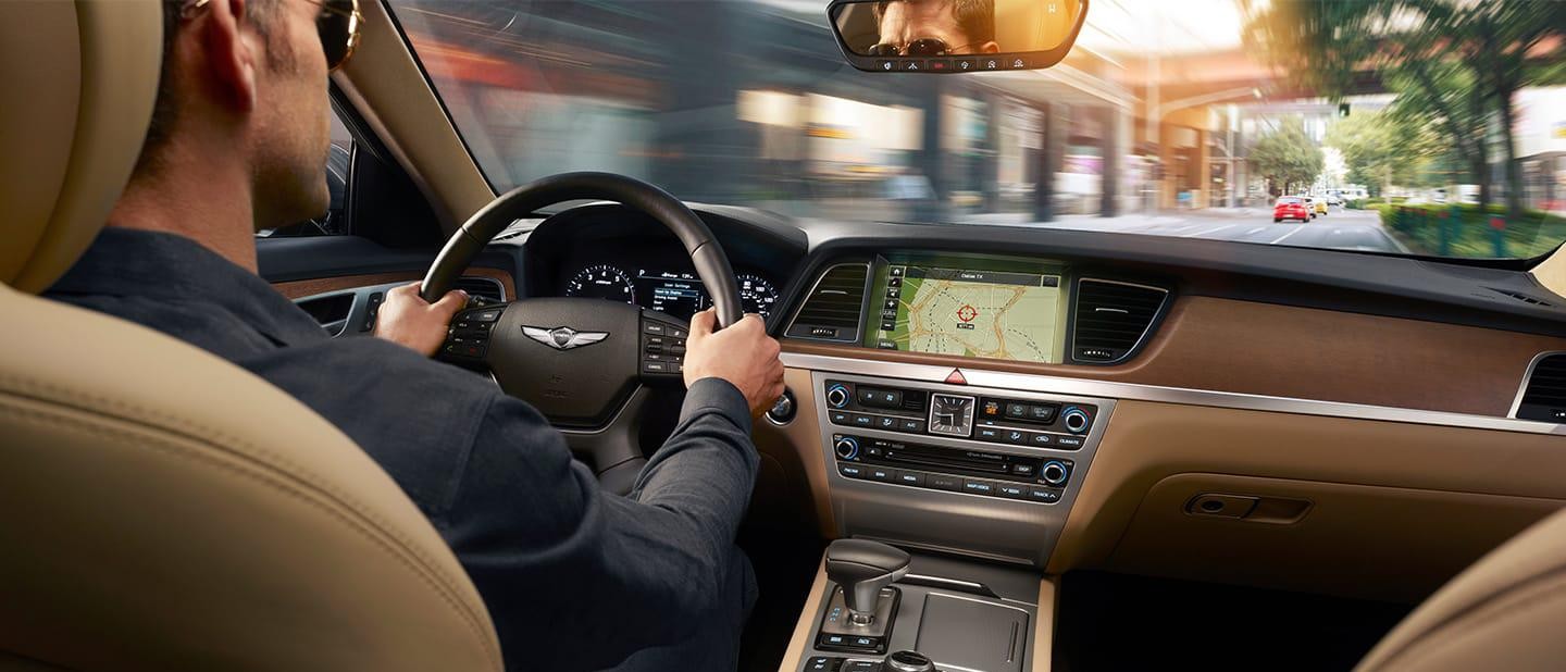 Interior of a Genesis vehicle with a gentleman driving