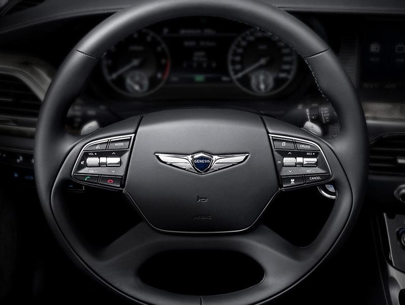 Close up view of a Genesis steering wheel.