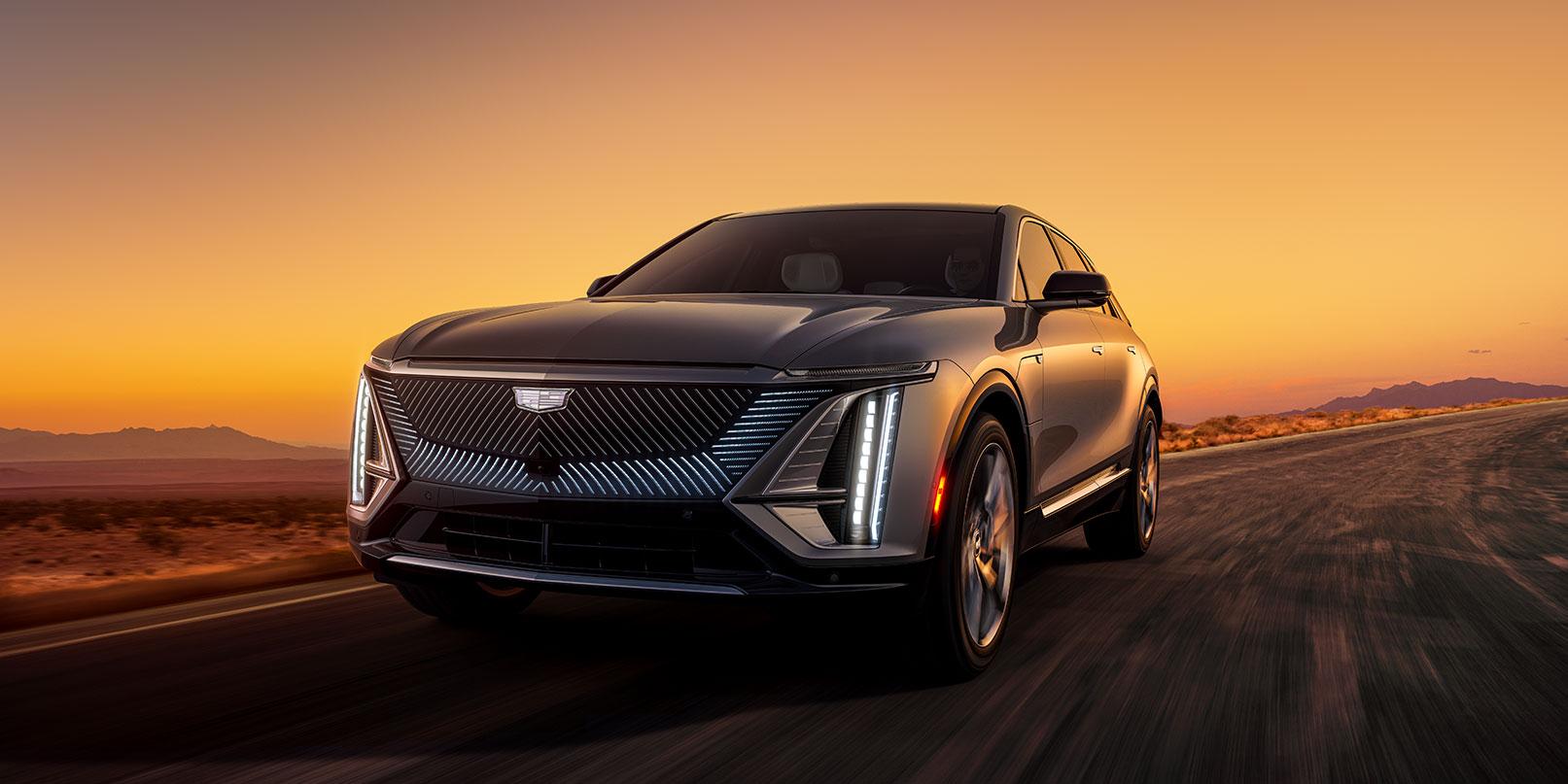 2023 Cadillac Lyriq driving down road with grille the center of focus
