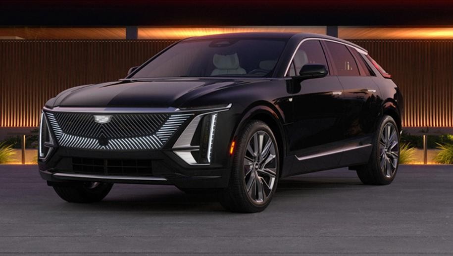 A Cadillac Lyriq Electric Vehicle Parked In Front of a Home at Dusk