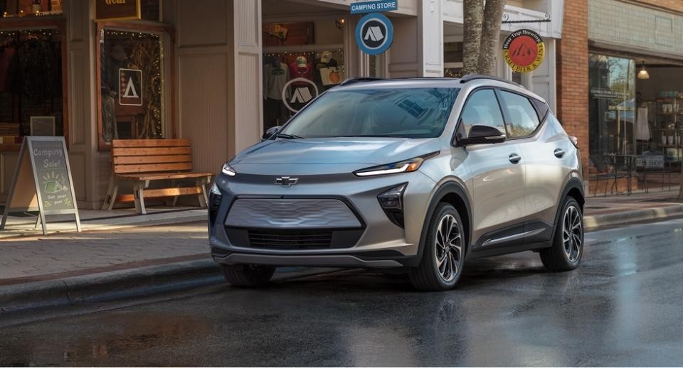 Chevrolet Bolt EV parked on the street in front of a store front