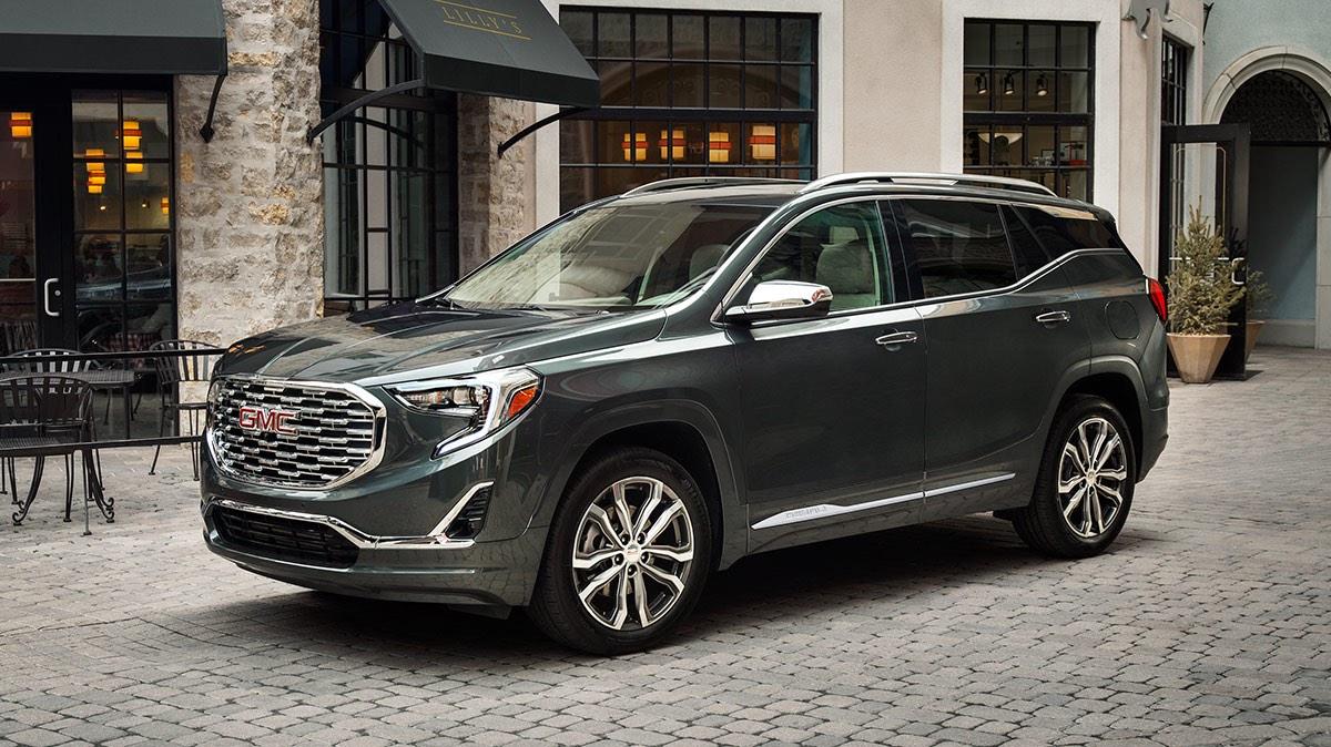 2020 GMC Terrain front passenger side view parked in front of a city restaurant