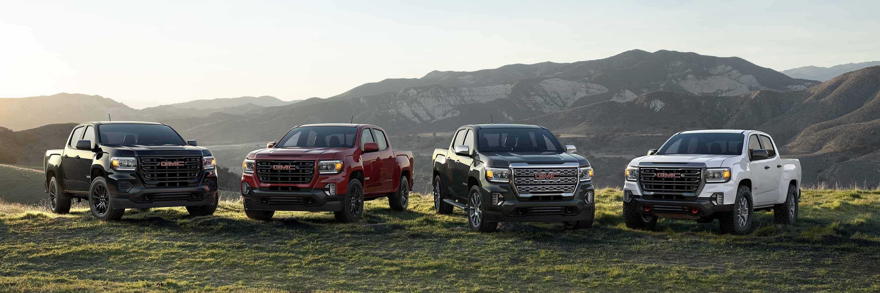 GMC Canyon Trucks parked in front of mountain