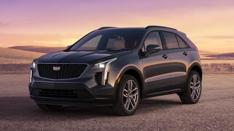 A grey 2023 Cadillac XT4 parked on a deserted land.