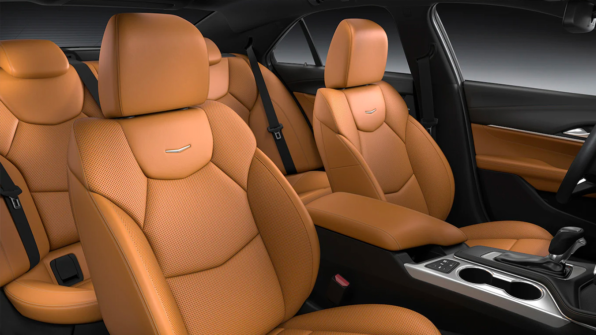 Detail view of the orange-accented black leather seats in the Cadillac CT4. 