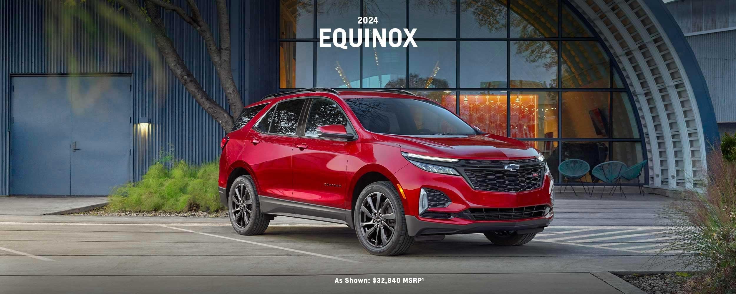 Red Chevrolet Equinox parked near a restaurant