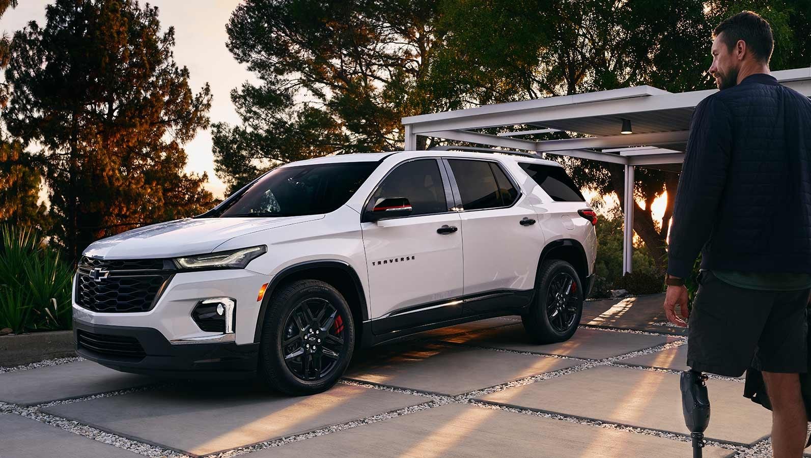 The 2023 Chevrolet Traverse is parked outside the main door.