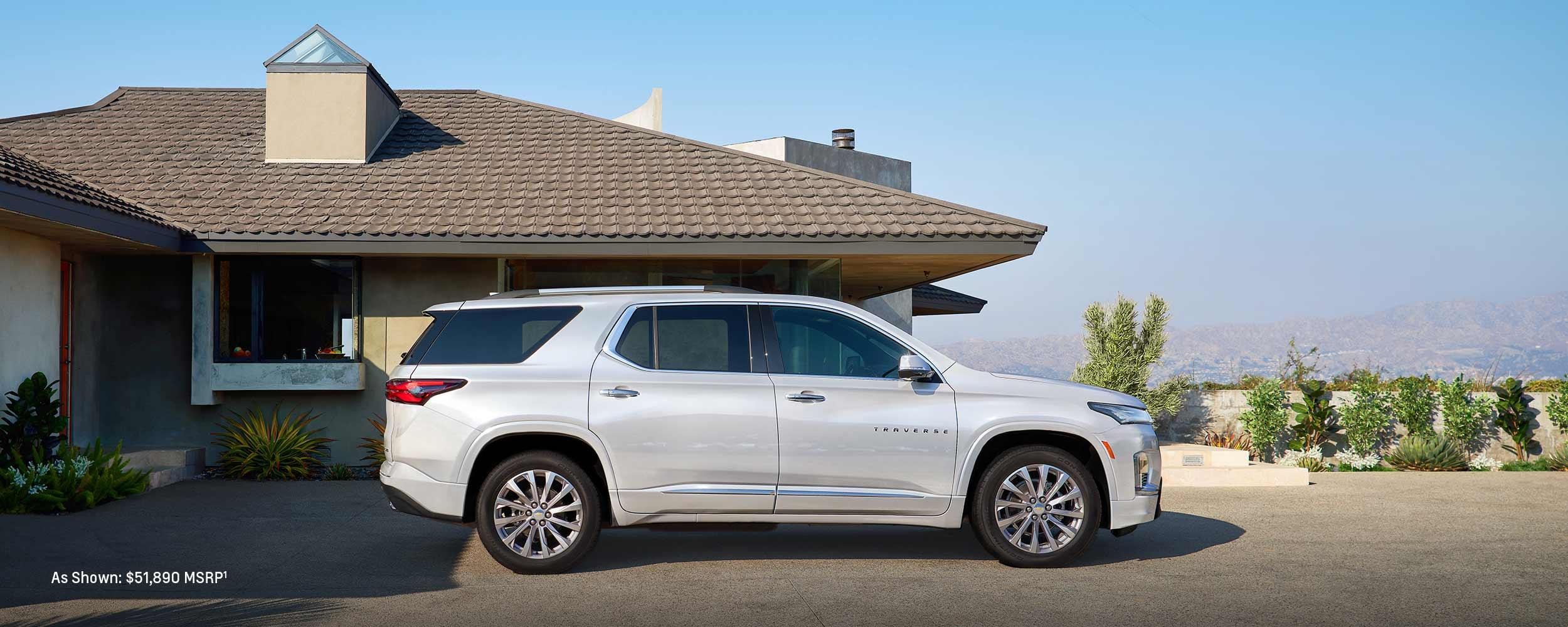 2023 Chevrolet Traverse parked in front of house.