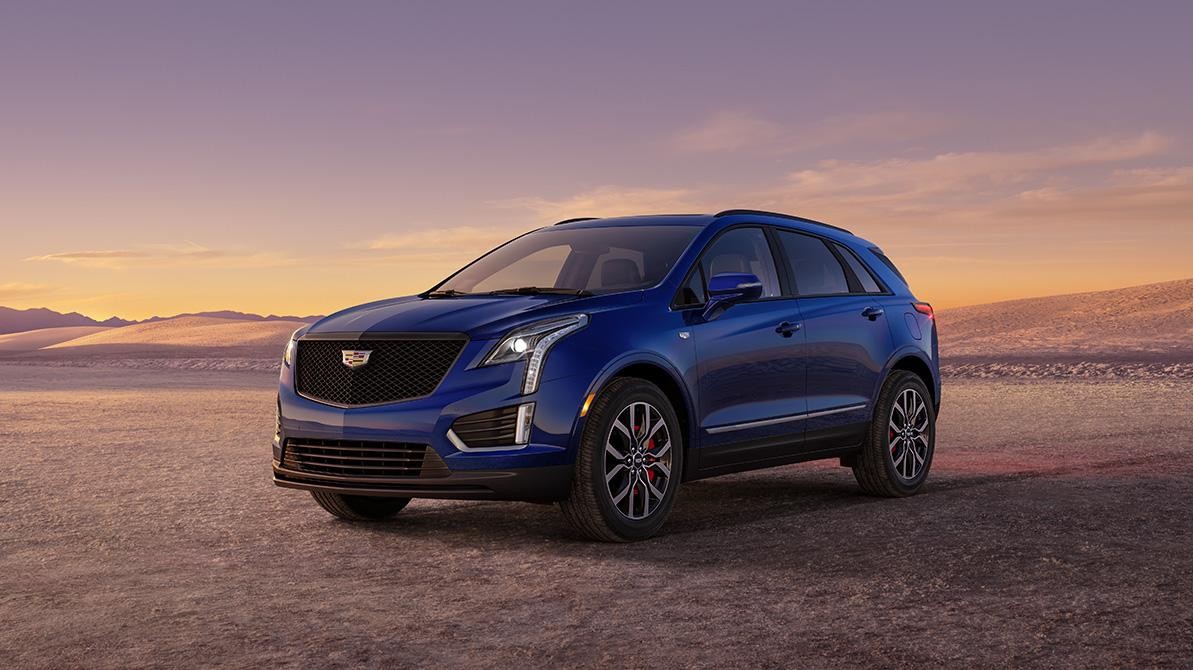 The 2024 Cadillac XT5 Parked in a Mountainous Landscape During a Sunset