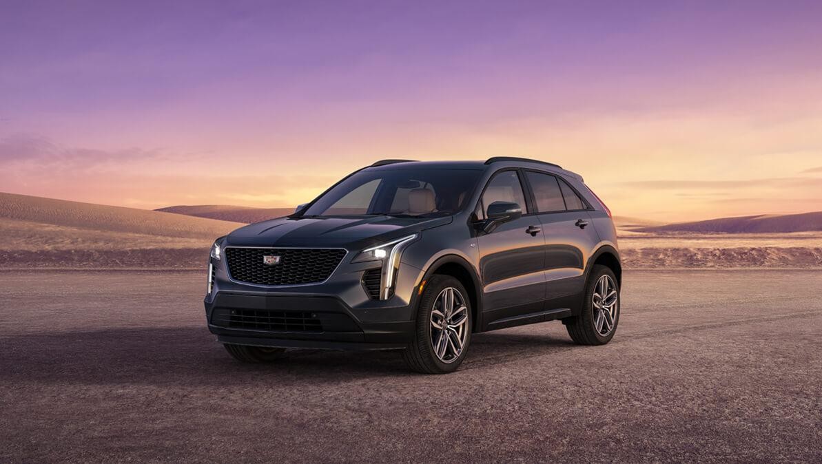 A grey 2023 Cadillac XT4 parked on a deserted land.