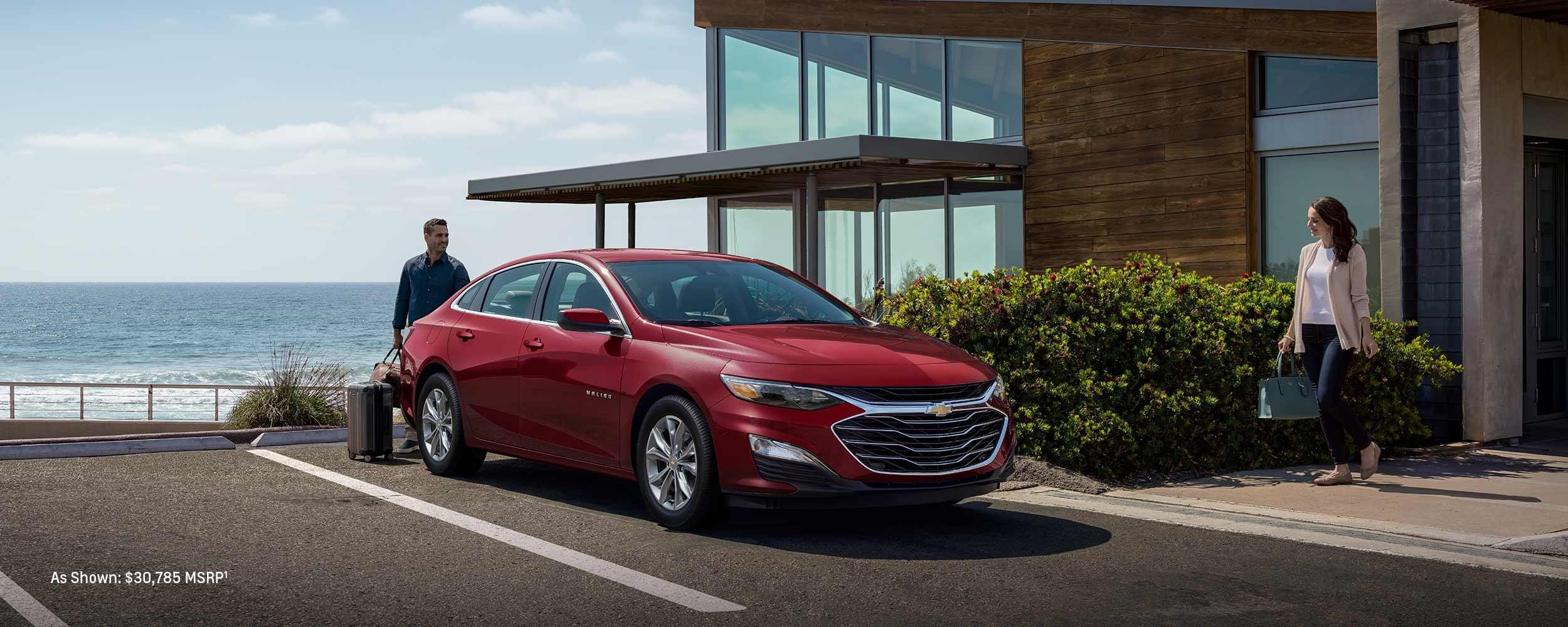 2023 Chevrolet Malibu parked in front of house.