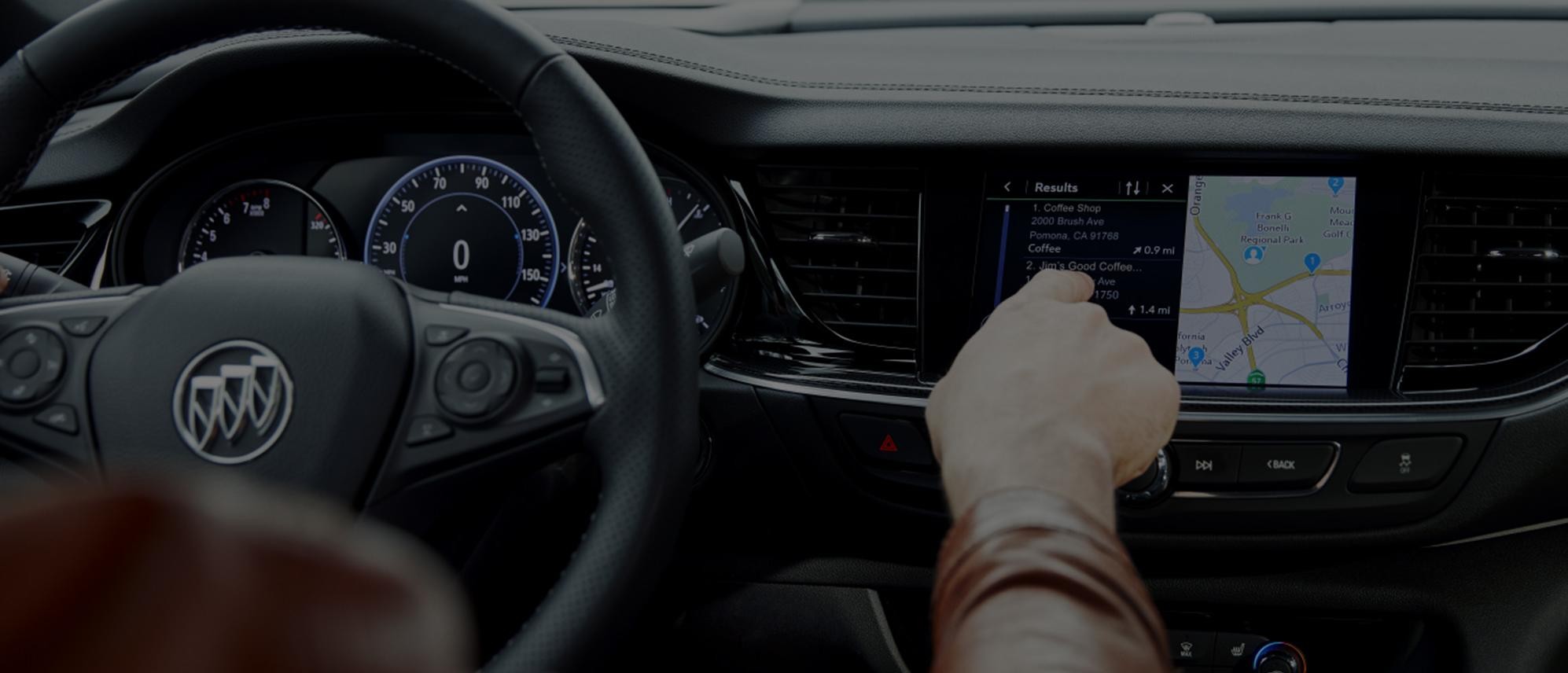 Woman pushing button on display in Buick