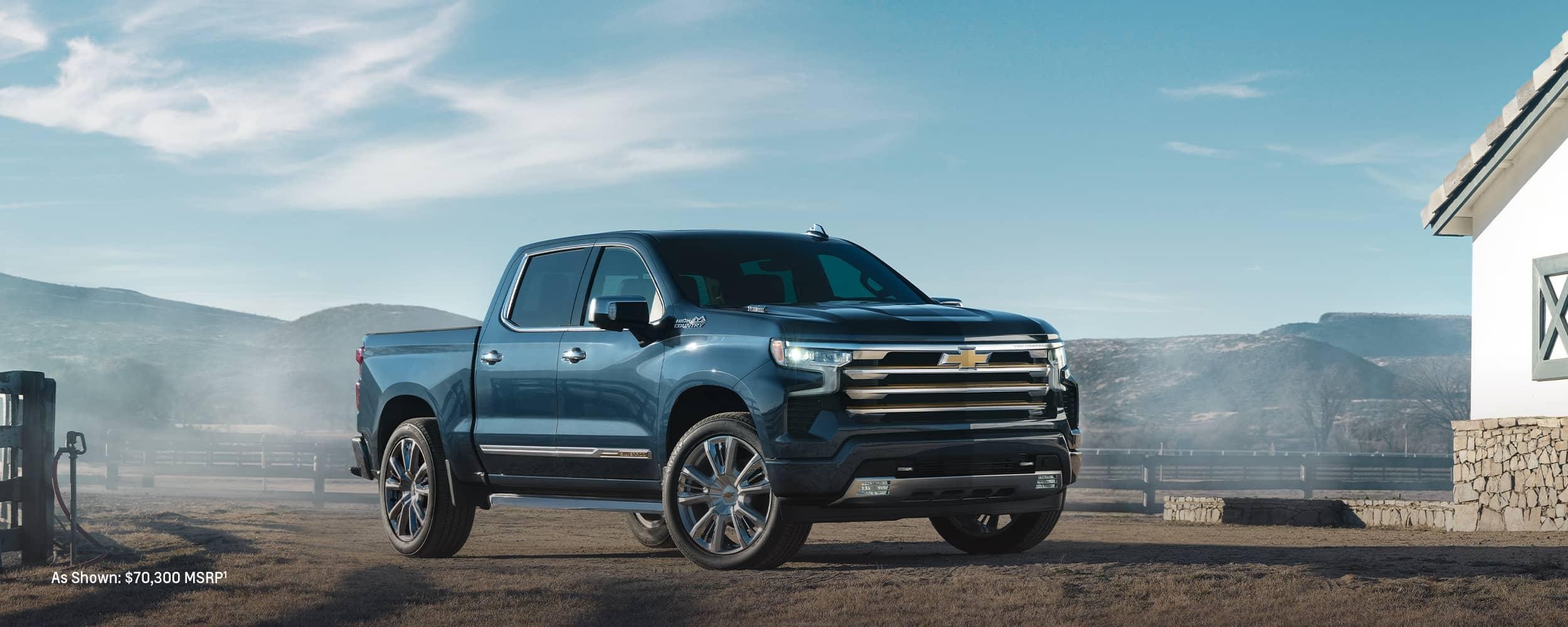 A blue Chevy Silverado HD parked in open space