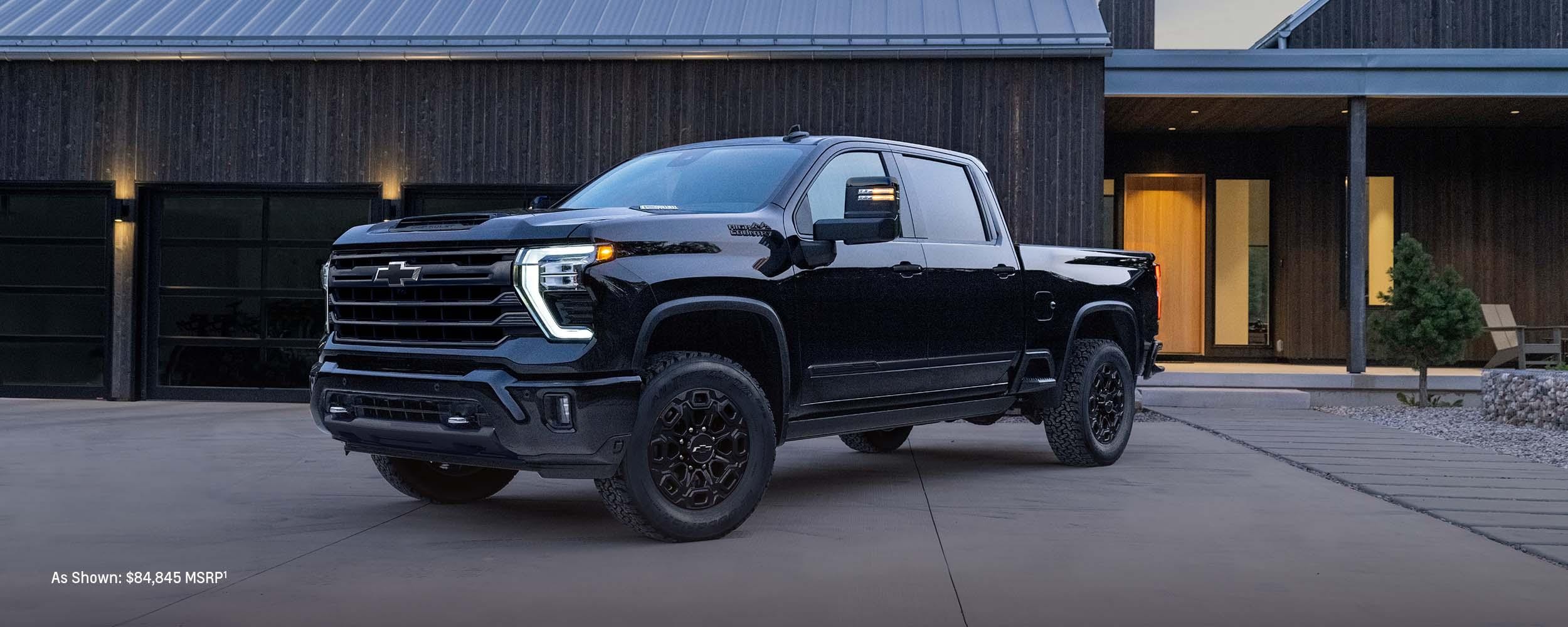 2024 Chevrolet Silverado HD parked in front of house.