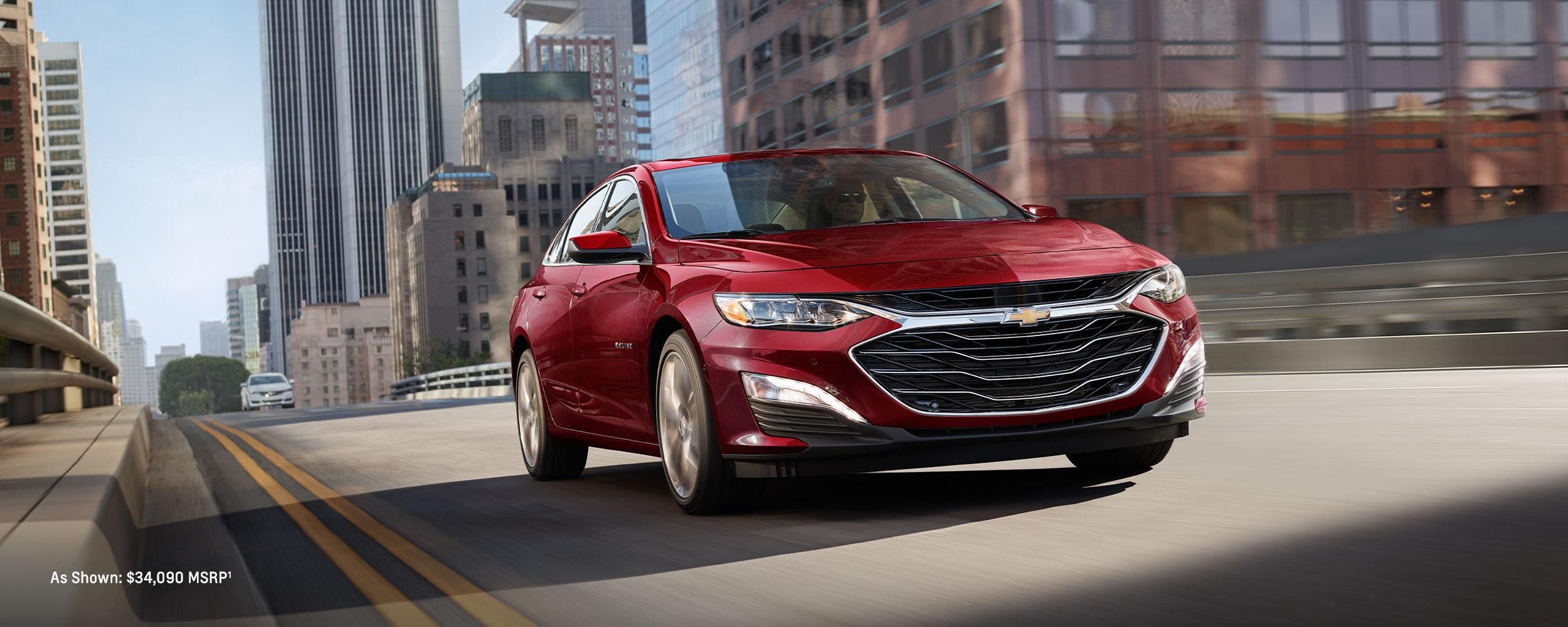 Red 2024 Chevrolet Malibu driving on the road