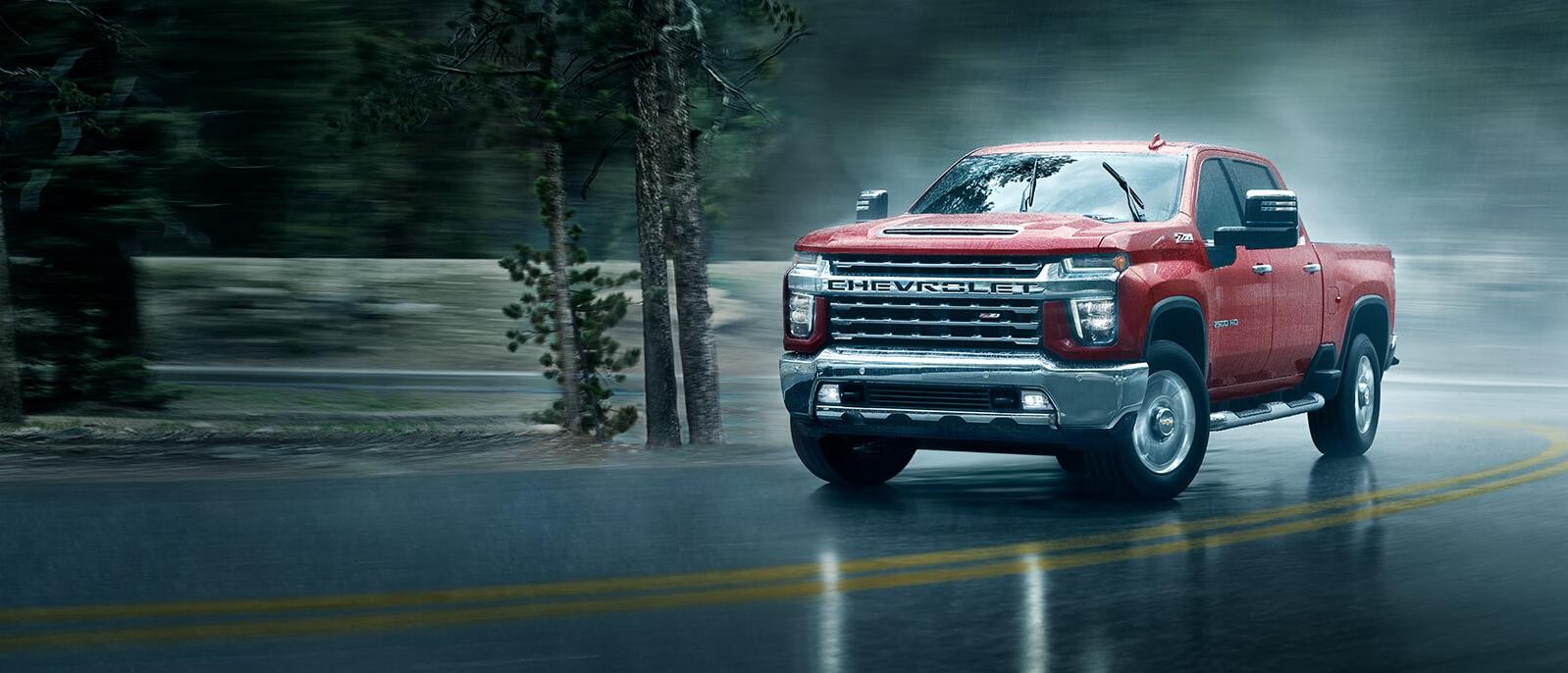 2021 Chevy Silverado 2500HD driving through a rainy day.