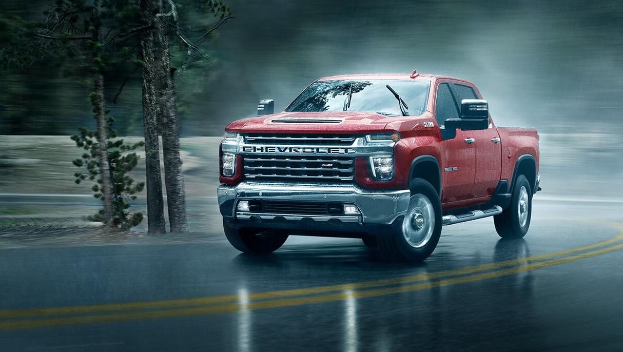 2021 Chevy Silverado 2500HD driving through a rainy day.