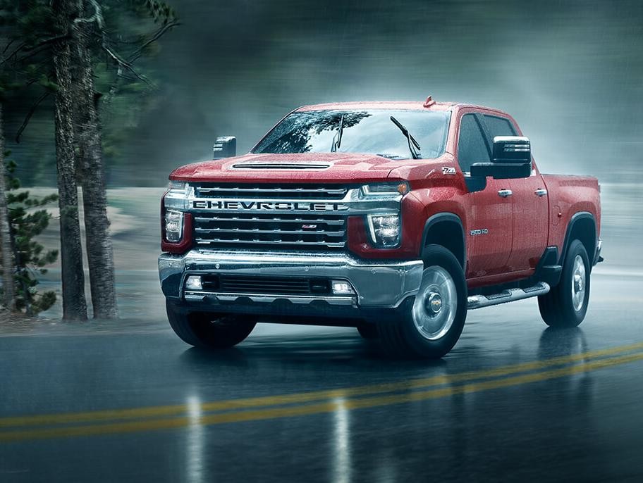 2021 Chevy Silverado 2500HD driving through a rainy day.