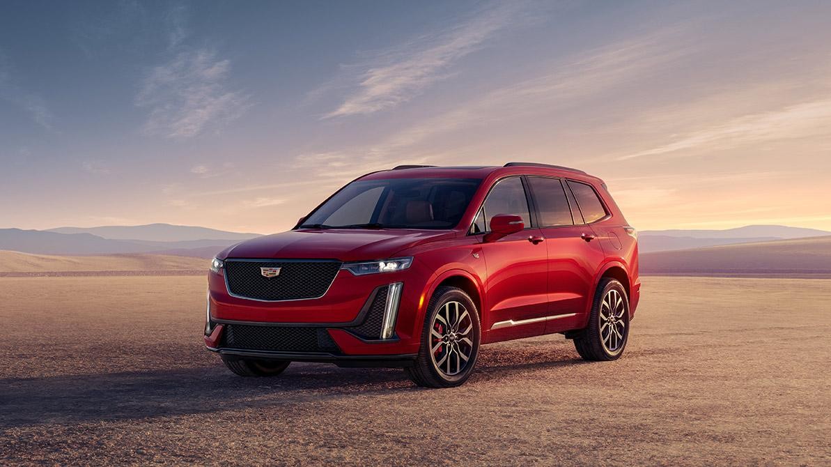 The Cadillac XT6 Parked in the Desert with Mountains in the Distance During Sunrise