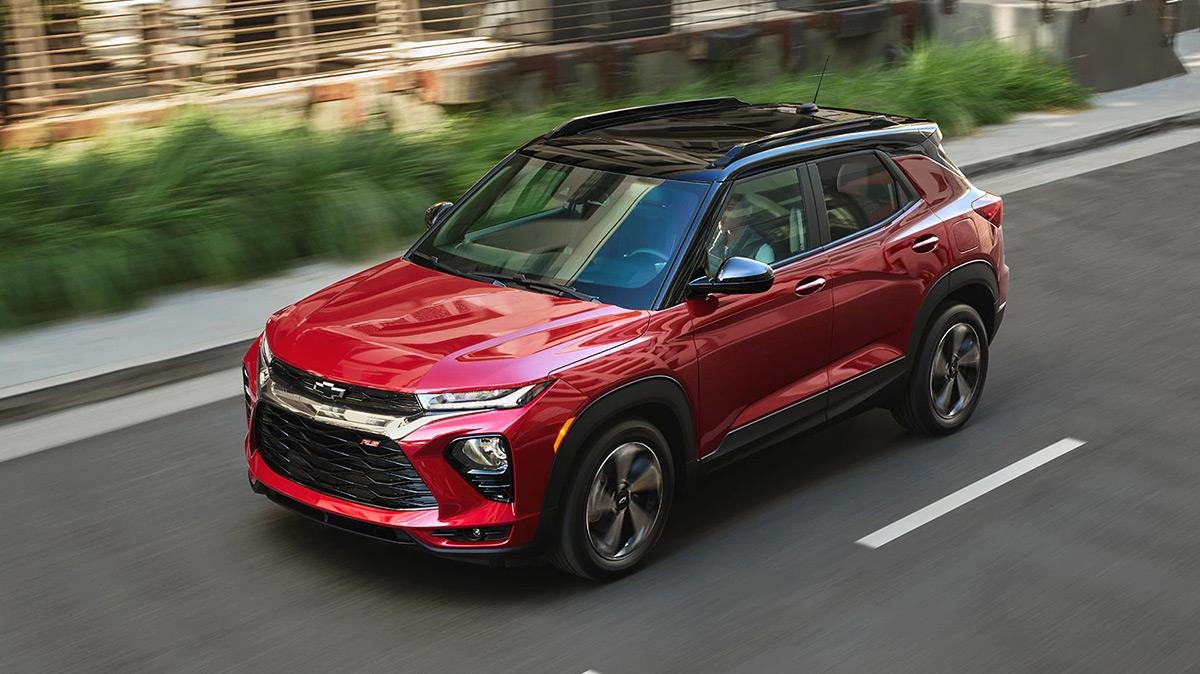 Red Trailblazer driving on a road