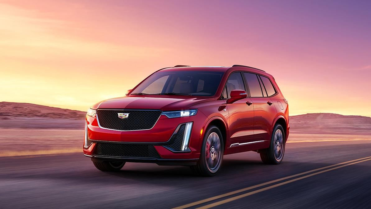 The Cadillac XT6 Driving on an Open Road in the Desert During Sunset