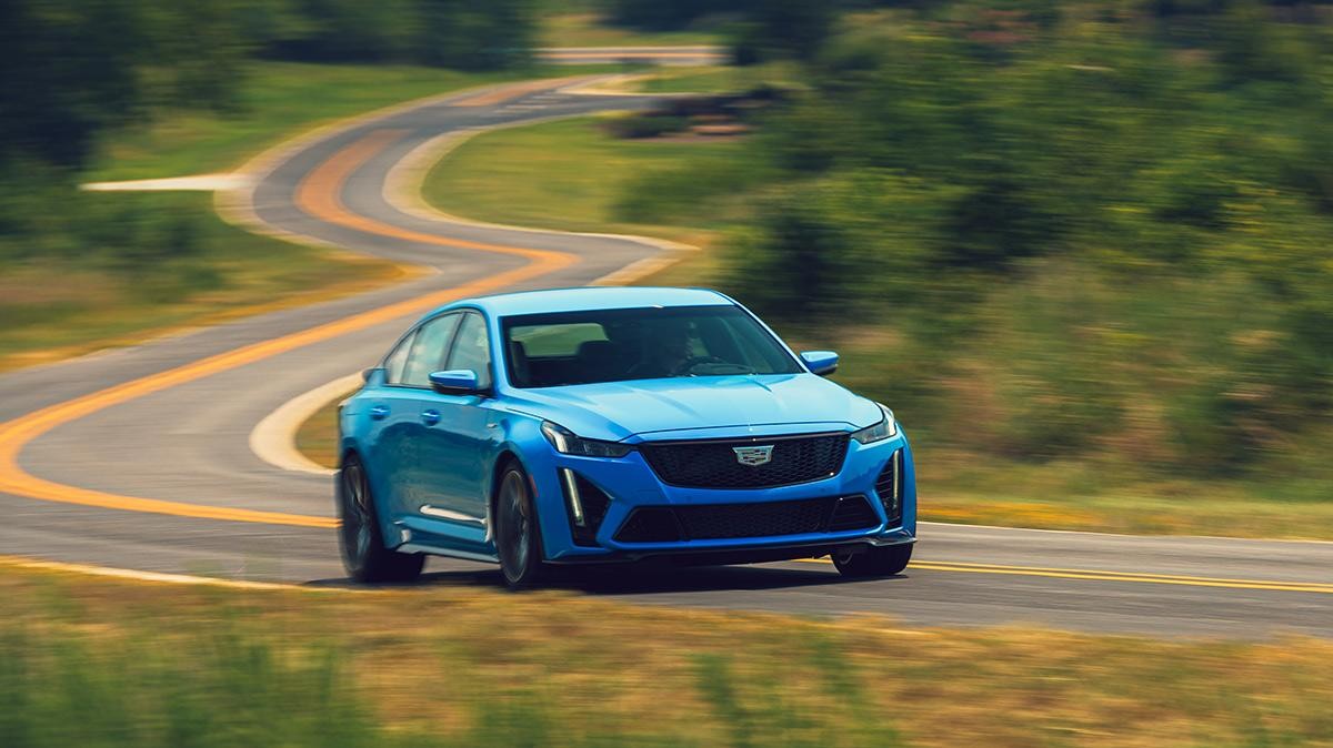 Blue Cadillac CT5-V driving on curvy country road