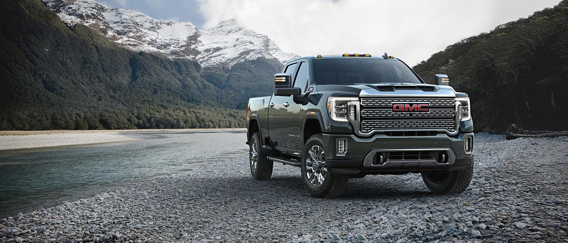 A 2024 GMC  Sierra HD parked near a river.