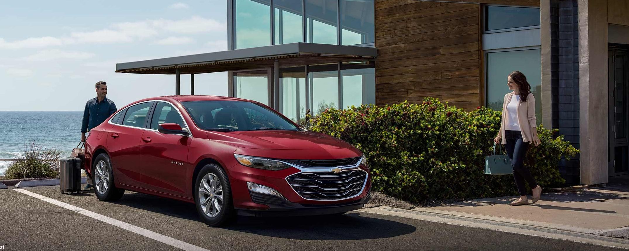 2023 Chevrolet Malibu parked in front of house.