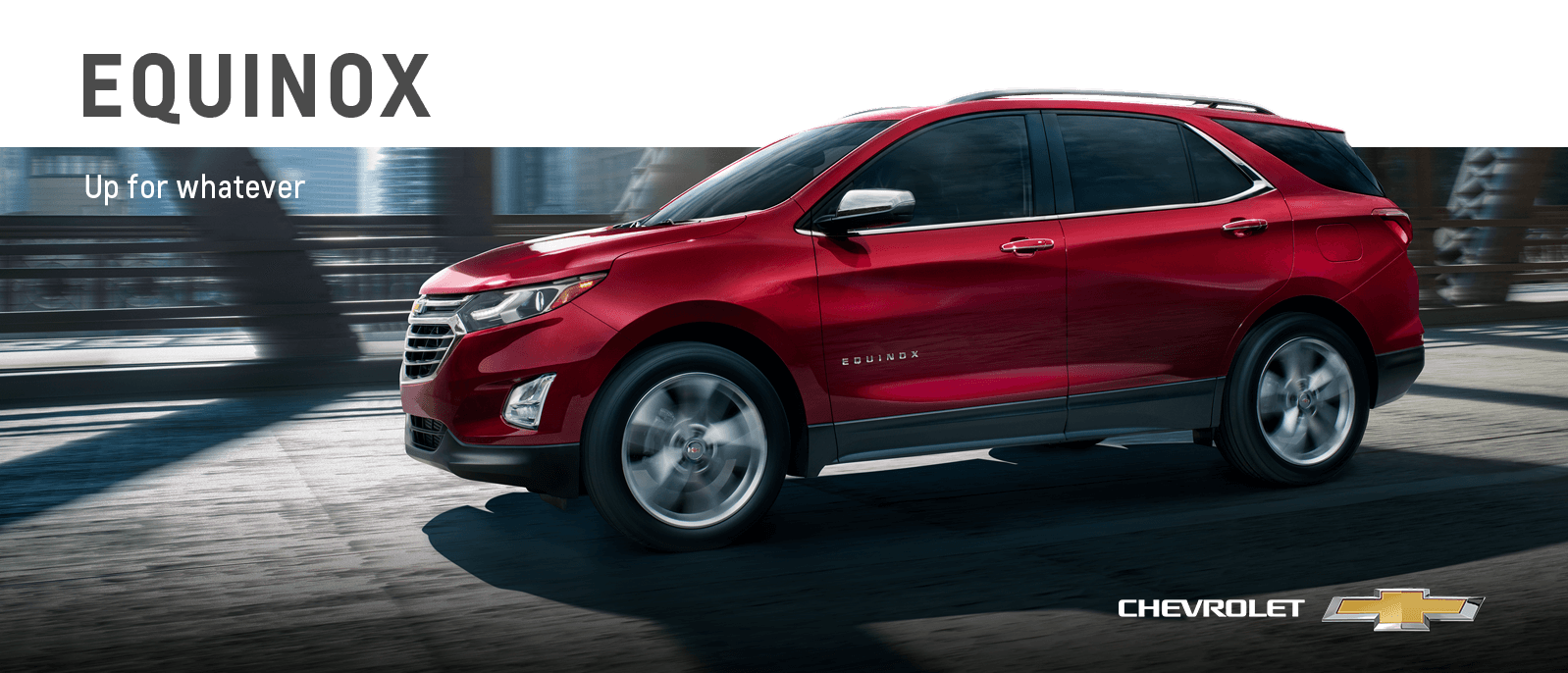 A red Chevy Equinox driving on a bridge. 