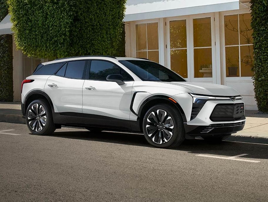 White 2024 Chevrolet Blazer EV is parked at roadside.