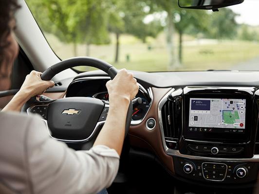 Woman driving chevy with navigation on screen