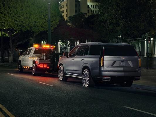 Cadilac getting towed at night time